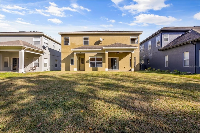 back of house with central AC and a lawn