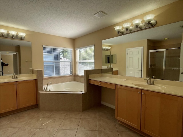 full bath with tile patterned flooring, a shower stall, a bath, a sink, and a textured ceiling