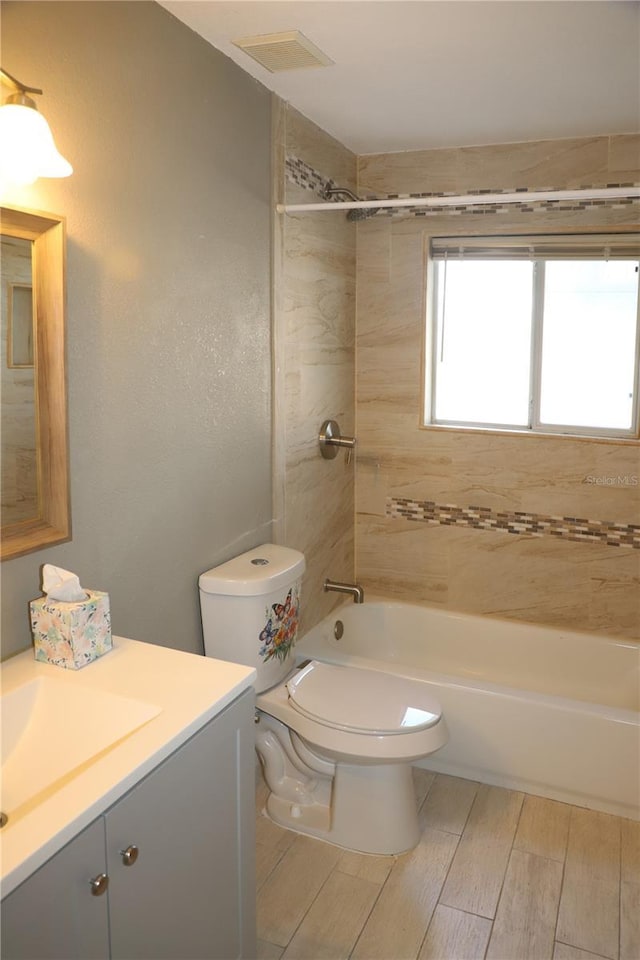 full bathroom with vanity, toilet, and tiled shower / bath