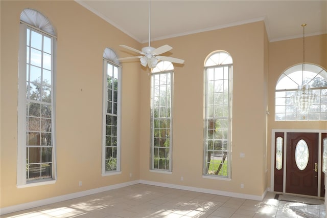 entryway featuring light tile patterned floors, ceiling fan with notable chandelier, and ornamental molding