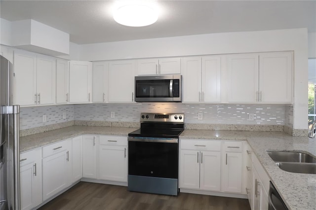 kitchen with tasteful backsplash, white cabinetry, sink, stainless steel appliances, and dark wood-type flooring