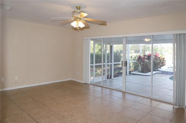 tiled empty room featuring ceiling fan