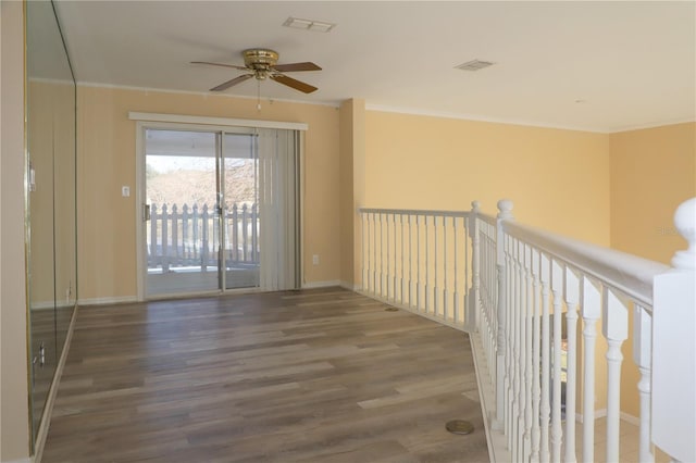 spare room with ceiling fan, ornamental molding, and wood-type flooring