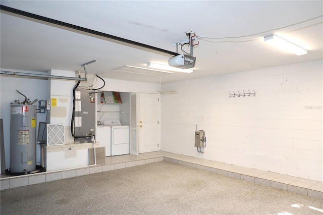 garage with water heater, a garage door opener, and washer and clothes dryer