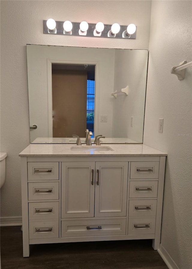 1001 Willa Lake Cir, Oviedo, FL 32765 - bathroom featuring wood finished floors, vanity, toilet, and baseboards