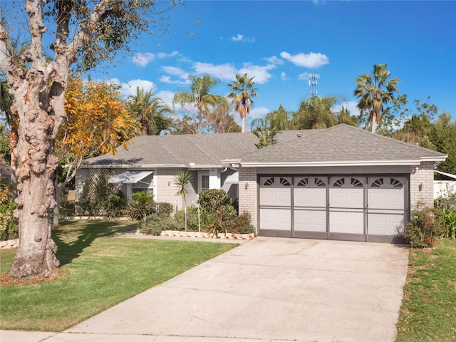 ranch-style house with a garage and a front yard