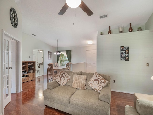 living room featuring lofted ceiling, dark wood-type flooring, french doors, and ceiling fan