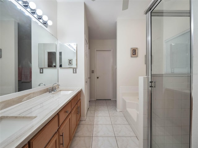 bathroom with independent shower and bath, vanity, and tile patterned floors