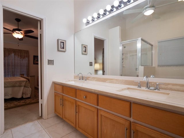 bathroom with walk in shower, ceiling fan, tile patterned floors, and vanity