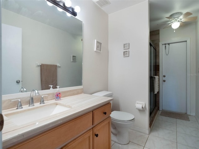 bathroom with toilet, an enclosed shower, vanity, ceiling fan, and tile patterned flooring