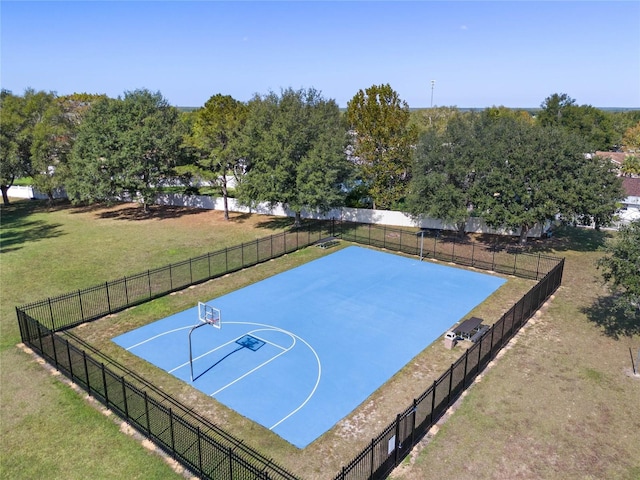 view of basketball court featuring a yard