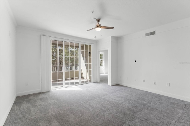 empty room featuring carpet flooring and ceiling fan