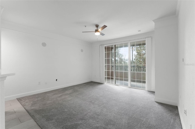 carpeted spare room featuring ceiling fan