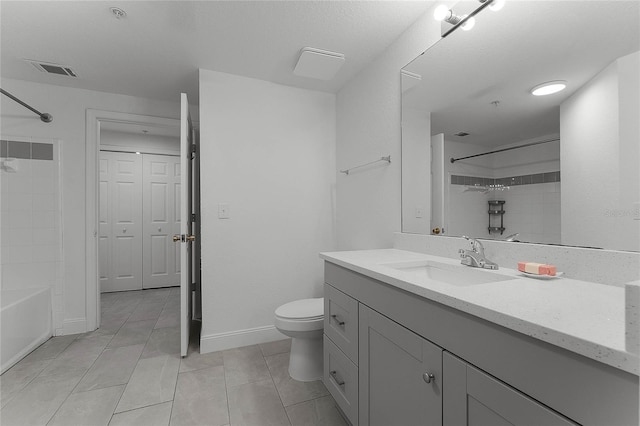 full bathroom featuring vanity, tiled shower / bath, tile patterned floors, and toilet