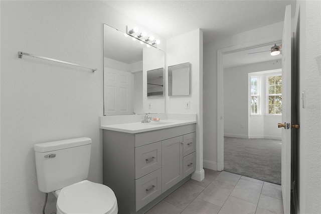 bathroom featuring ceiling fan, tile patterned floors, vanity, and toilet