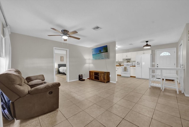 tiled living room with ceiling fan