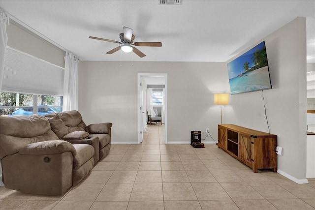 living room featuring light tile patterned floors and ceiling fan