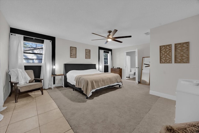 bedroom with a textured ceiling, ceiling fan, and light tile patterned flooring