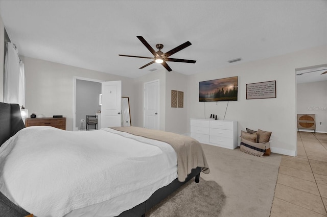 tiled bedroom featuring ceiling fan