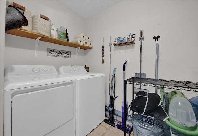 laundry area with light tile patterned floors and washing machine and dryer