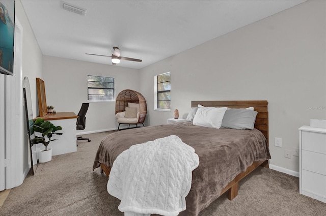 bedroom with ceiling fan and light carpet