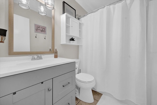 bathroom with vanity, tile patterned floors, and toilet