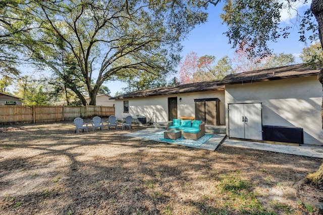 rear view of house featuring an outdoor living space and a patio