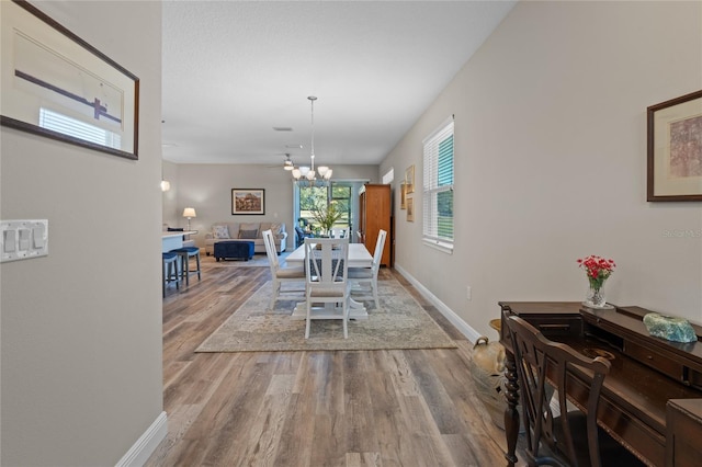 dining area featuring hardwood / wood-style flooring and a chandelier