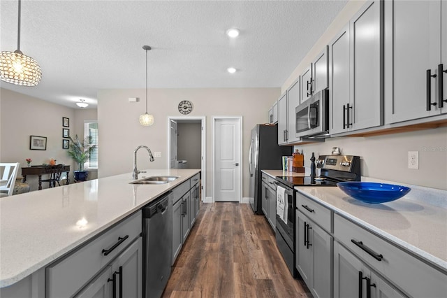 kitchen featuring pendant lighting, appliances with stainless steel finishes, sink, and gray cabinetry