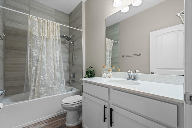 full bathroom featuring vanity, wood-type flooring, shower / bathtub combination with curtain, and toilet