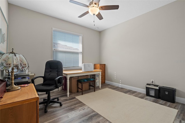 office area with ceiling fan and dark hardwood / wood-style floors