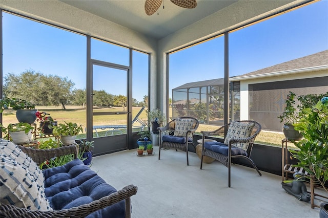 sunroom / solarium featuring ceiling fan