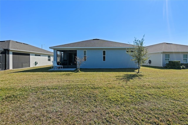 back of house with a sunroom and a yard