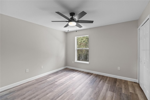 unfurnished bedroom featuring light hardwood / wood-style floors, a closet, and ceiling fan