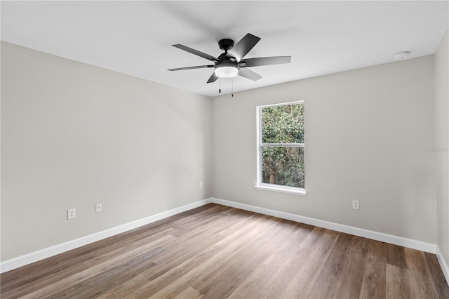 unfurnished room with hardwood / wood-style floors and ceiling fan