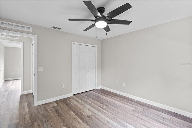 unfurnished bedroom with a closet, ceiling fan, and light hardwood / wood-style flooring