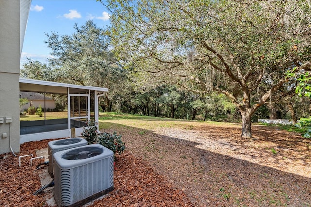 view of yard with a sunroom and cooling unit