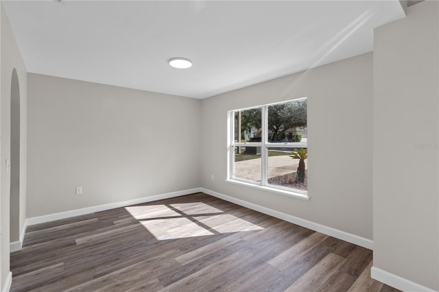 unfurnished room featuring dark hardwood / wood-style floors