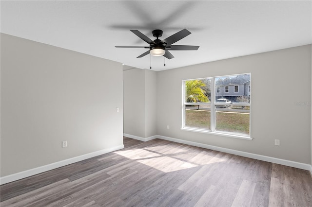 unfurnished room featuring hardwood / wood-style floors and ceiling fan