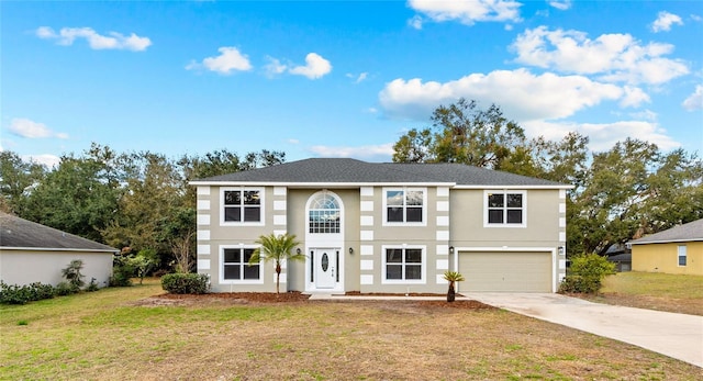 view of front of home featuring a garage and a front lawn