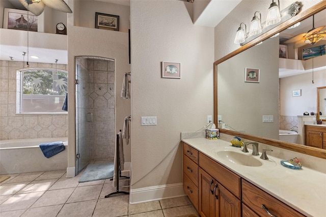 bathroom with tile patterned floors, separate shower and tub, and vanity