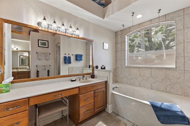 bathroom featuring tile patterned flooring, vanity, and shower with separate bathtub