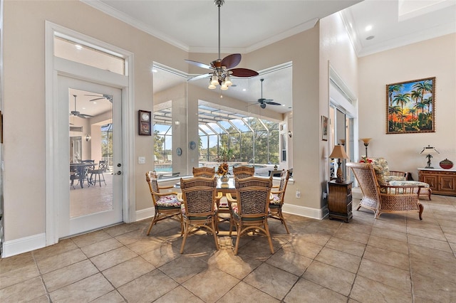 tiled dining area featuring a high ceiling, crown molding, and ceiling fan