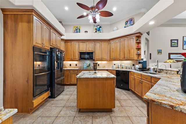 kitchen with a kitchen island, sink, ornamental molding, black appliances, and light stone countertops