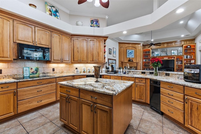 kitchen featuring a center island, light stone countertops, ornamental molding, black appliances, and kitchen peninsula