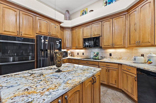 kitchen with tasteful backsplash, crown molding, light stone counters, and black appliances