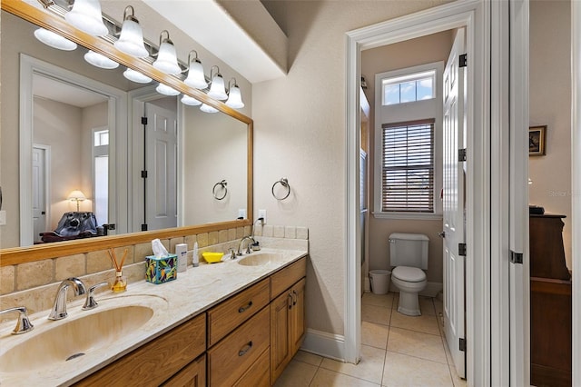 bathroom featuring tile patterned floors, toilet, and vanity