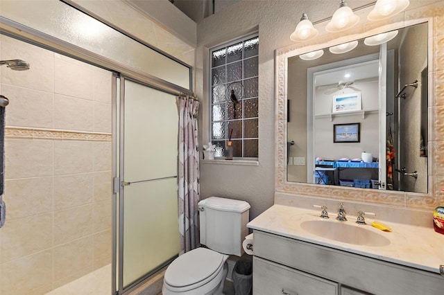 bathroom featuring vanity, toilet, and a shower with shower door