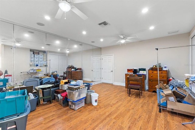 misc room with light hardwood / wood-style flooring and ceiling fan