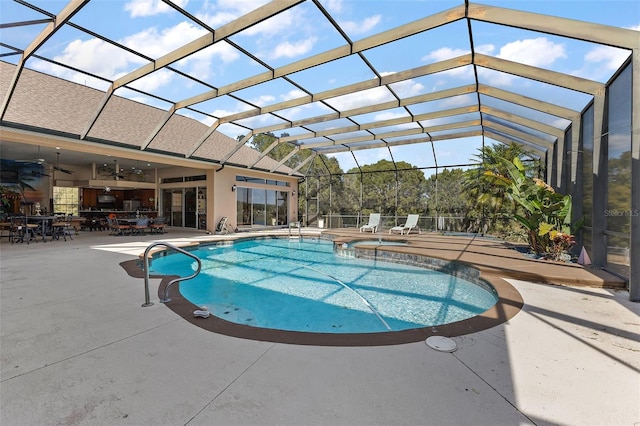 view of pool featuring a lanai, a patio, ceiling fan, and an in ground hot tub